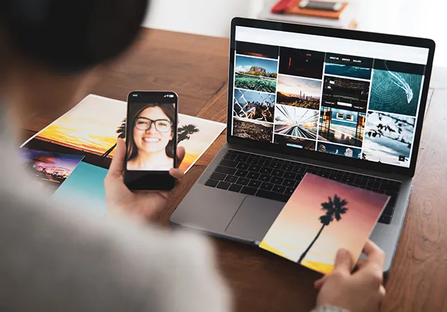 A woman using a laptop to edit photos.