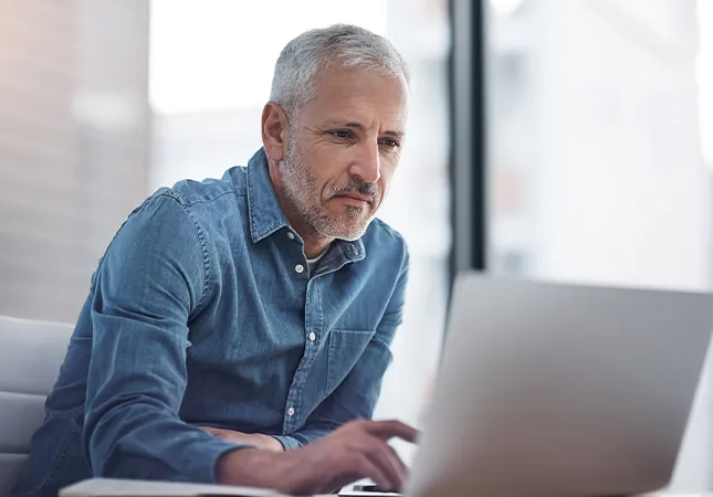 A man typing on a laptop.