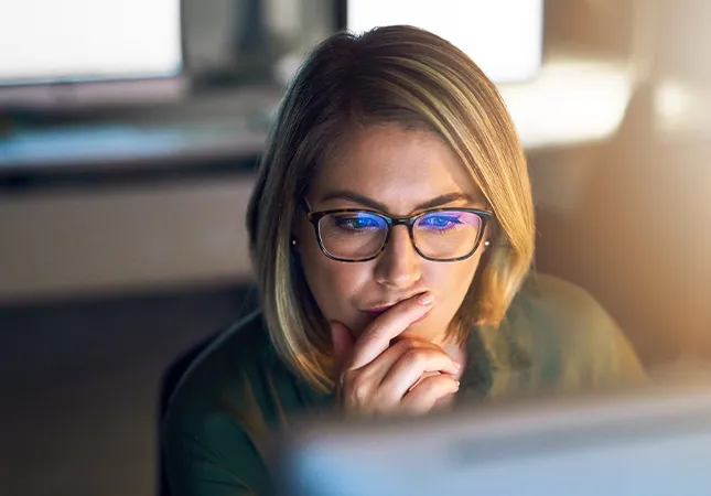 A woman looking at a computer screen.