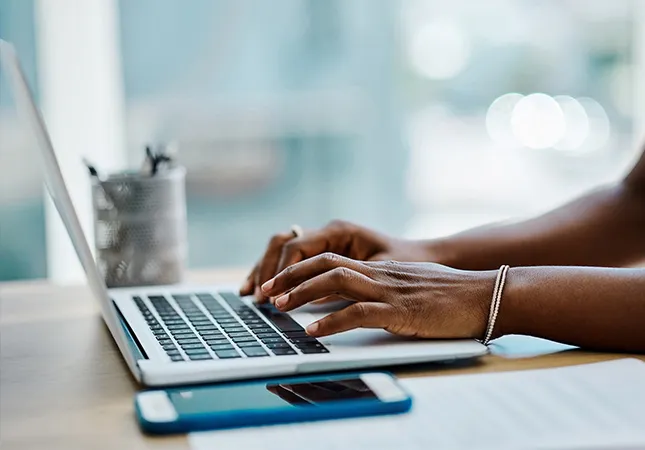 A person typing on a laptop.